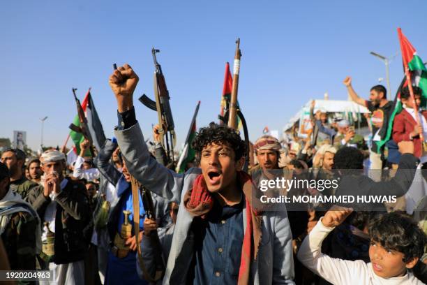 Yemeni demonstrators shout slogans during a protest following US and British forces strikes, in the Huthi-controlled capital Sanaa on January 12,...