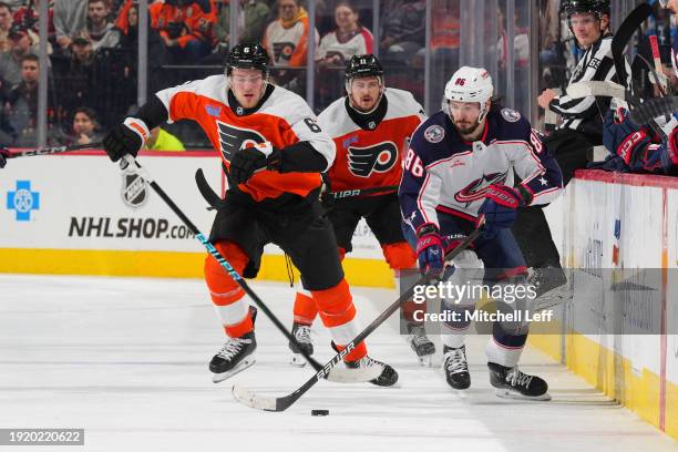 Kirill Marchenko of the Columbus Blue Jackets controls the puck against Travis Sanheim of the Philadelphia Flyers at the Wells Fargo Center on...