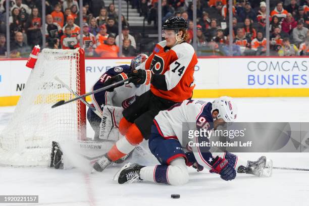 Owen Tippett of the Philadelphia Flyers collides with Jack Roslovic of the Columbus Blue Jackets at the Wells Fargo Center on January 4, 2024 in...