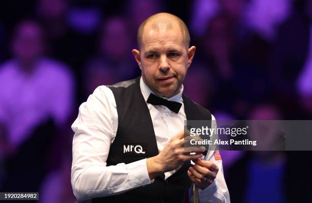 Barry Hawkins of England reacts to a shot in his first round match against Neil Robertson of Australia during day three of the MrQ Masters Snooker...