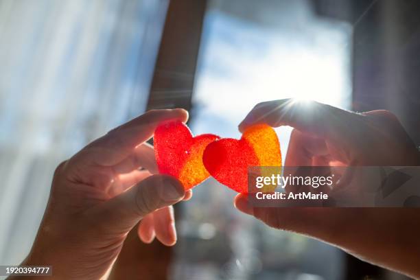 child holding heart-shaped candies - valentines day stock pictures, royalty-free photos & images