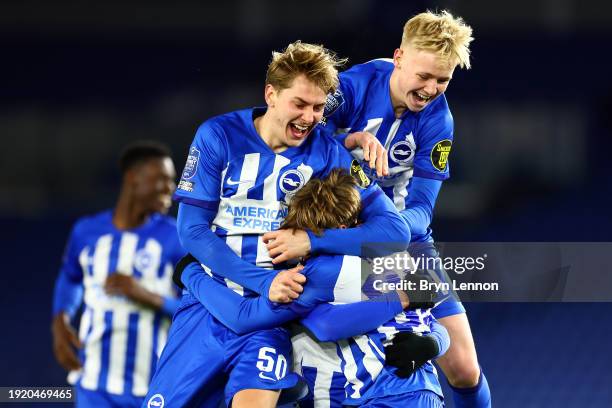 Harry Howell of Brighton and Hove Albion U21 celebrates with team mates after scoring in the penalty shoot out to win the Bristol Street Motors...