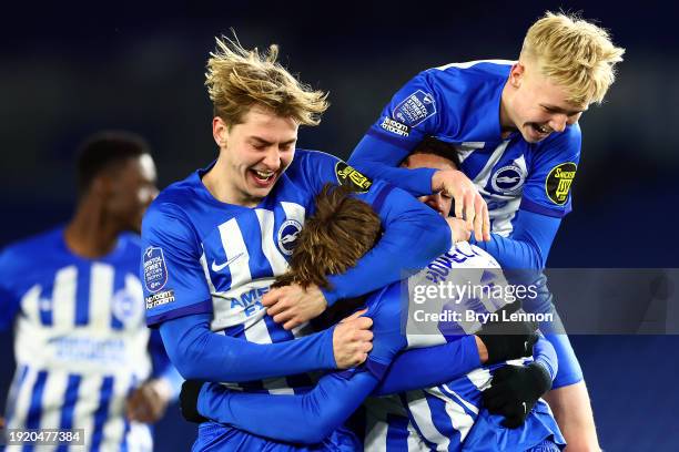 Harry Howell of Brighton and Hove Albion U21 celebrates with team mates after scoring in the penalty shoot out to win the Bristol Street Motors...