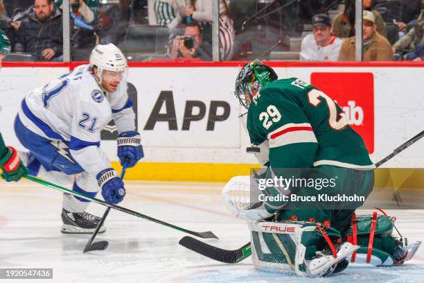 Marc-Andre Fleury of the Minnesota Wild makes a save against Brayden Point of the Tampa Bay Lightning during the game at the Xcel Energy Center on...