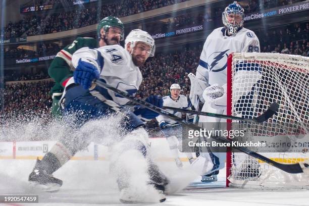 Calvin de Haan and Andrei Vasilevskiy of the Tampa Bay Lightning defend against Jake Middleton of the Minnesota Wild during the game at the Xcel...