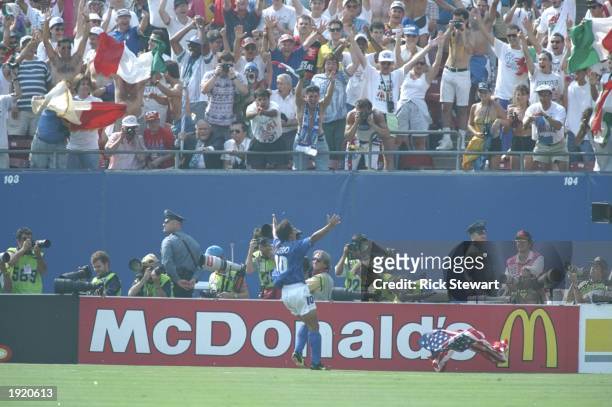 Robert Baggio of Italy celebrates with the crowd after scoring during the World Cup semi-final against Bulgaria at the Giants Stadium in New York,...