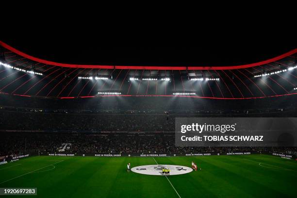 Bayern Munich and Hoffenheim's players observe a moment of silence in honour of late German football legend Franz Beckenbauer ahead of the German...