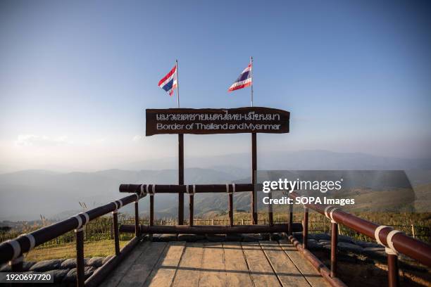 Sign depicting the Thai-Myanmar border with Thailand flags on top. The Chang Moob Military Outpost now turned into a tourist attraction spot, used to...