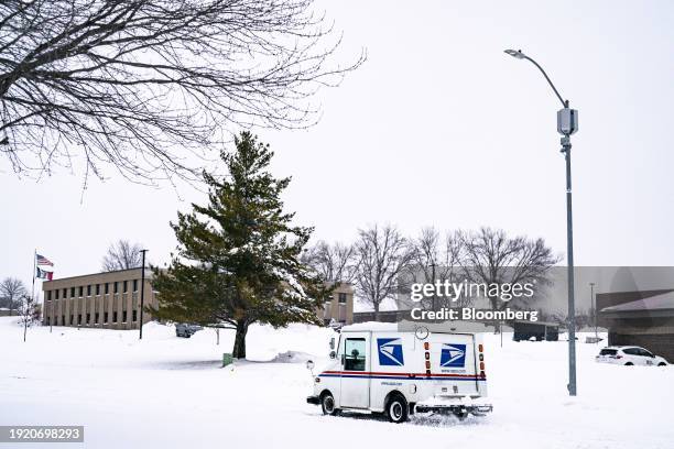 United States Postal Service truck drives through snow during a winter storm ahead of the Iowa caucus in West Des Moines, Iowa, US, on Friday, Jan....