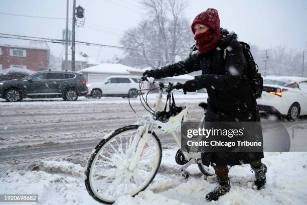 Rebecca Zimmerman moves along Harlem Avenue on her way to work in Oak Park from Forest Park as a winter storm hits the Chicago area with heavy snow...