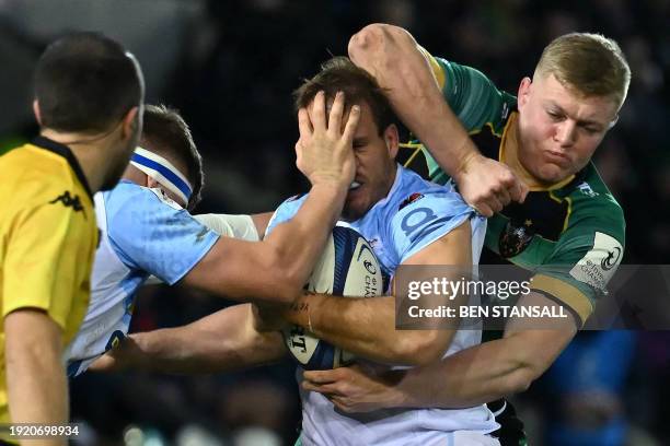 Bayonne's Argentinian hooker Facundo Bosch is tackled by his own player and Northampton Saints' English flanker Tom Pearson during the European Rugby...