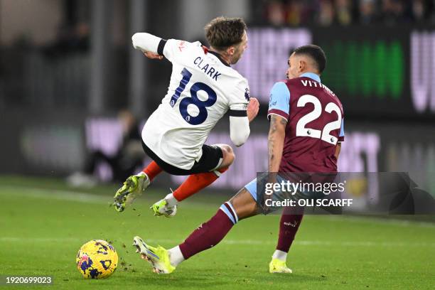 Luton Town's English midfielder Jordan Clark vies with Burnley's Brazilian defender Vitinho during the English Premier League football match between...