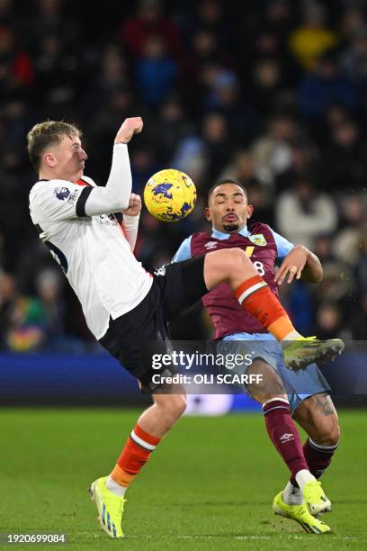 Luton Town's English midfielder Alfie Doughty vies with Burnley's Brazilian defender Vitinho during the English Premier League football match between...