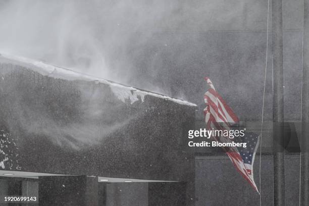 An American flag waves in the wind during a winter storm ahead of the Iowa caucus in Des Moines, Iowa, US, on Friday, Jan. 12, 2024. The polar vortex...