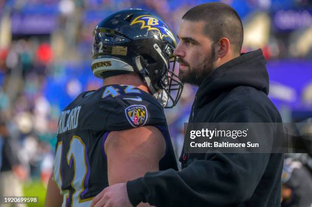 Still unable to play because of an injury, Baltimore Ravens tight end Mark Andrews chats with fullback Patrick Ricard during pregame for an AFC...