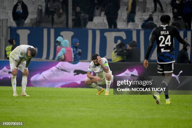 Marseille's French midfielder Jonathan Clauss and Marseille's French defender Samuel Gigot react at the end of French L1 football match between...