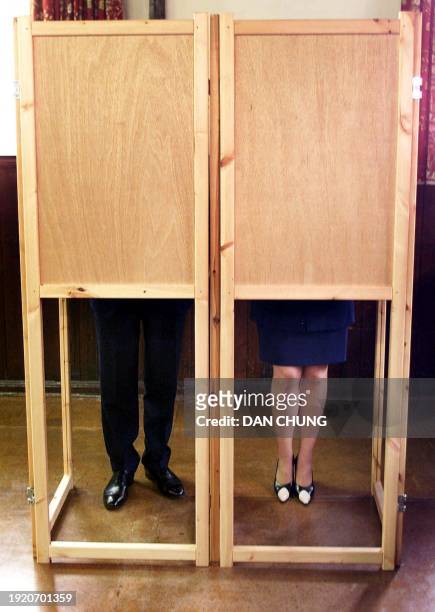 Conservative Party leader William Hague and his wife Ffion fil in their ballots prior to casting their votes at the Booth Memorial Institute polling...