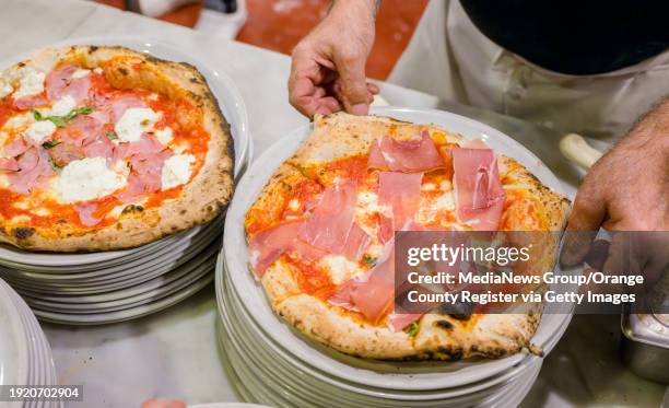 Franco Ceccarelli, owner of Fuoco Pizzeria Napoletana, prepares pizzas to be delivered to tables in Fullerton on Wednesday, January 3, 2024. Fuoco...