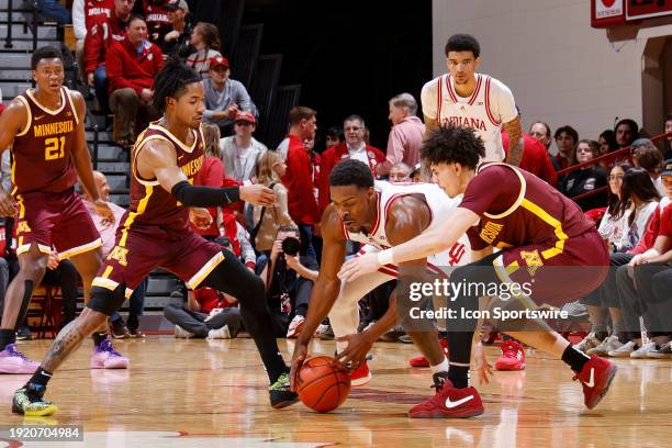 Indiana Hoosiers guard Xavier Johnson battles for a loose ball against Minnesota Golden Gophers guard Mike Mitchell Jr. And guard Elijah Hawkins...