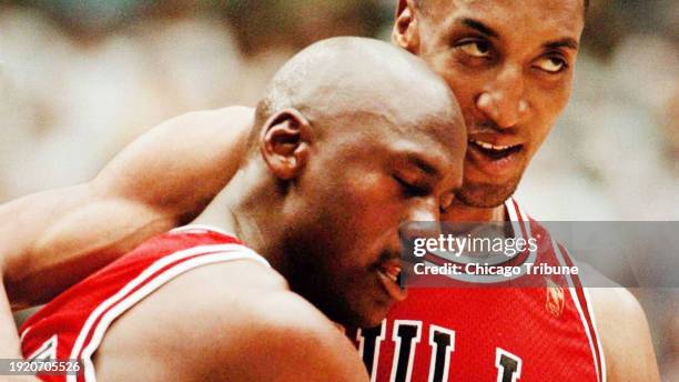 Chicago Bulls forward Scottie Pippen, right, assists teammate Michael Jordan off the court for a timeout against the Utah Jazz during Game 5 of the...