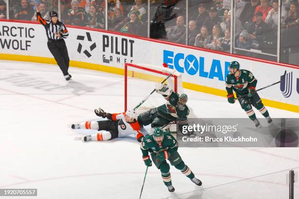 Cam Atkinson of the Philadelphia Flyers is called for a tripping penalty against Marc-Andre Fleury of the Minnesota Wild during the overtime period...