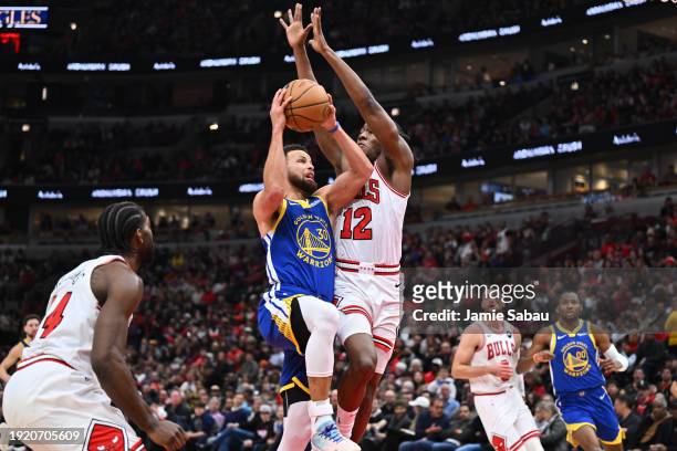 Stephen Curry of the Golden State Warriors drives to the basket while being guarded by Ayo Dosunmu of the Chicago Bulls in the second half on January...