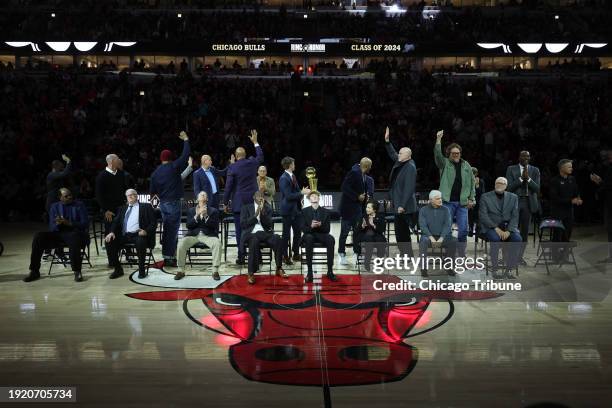 Members of the 1996 NBA championship team acknowledge fans as they are introduced at the Ring of Honor ceremony during halftime as the Bulls play...