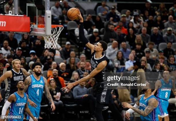 Victor Wembanyama of the San Antonio Spurs dunks past the Charlotte Hornets in the first half at Frost Bank Center on January 12, 2024 in San...