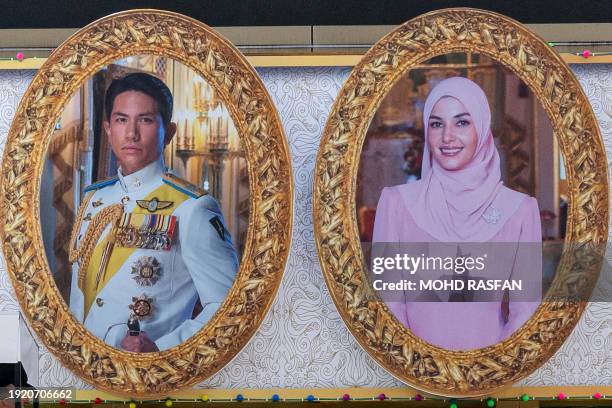 The portraits of groom Prince Abdul Mateen and his bride Yanh Mulia Anisha Rosnah are seen on a billboard ahead of their wedding procession in Bandar...