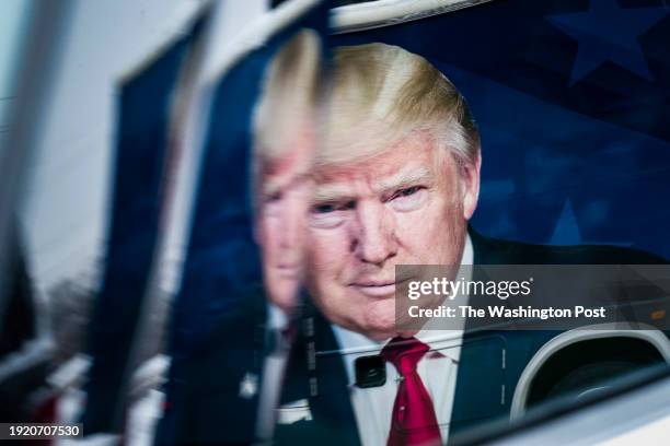 Urbandale, IA An image depicting former President Donald Trump is seen on the side of a tour bus before Donald Trump Jr., executive vice president of...