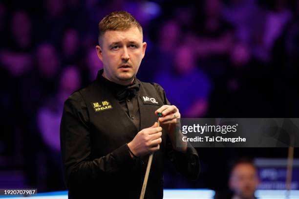 Kyren Wilson of England chalks the cue in the first round match against Judd Trump of England on day 3 of the 2024 MrQ Masters Snooker at Alexandra...