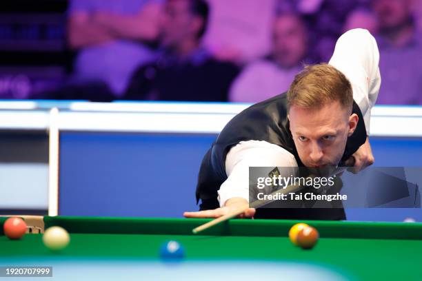 Judd Trump of England plays a shot in the first round match against Kyren Wilson of England on day 3 of the 2024 MrQ Masters Snooker at Alexandra...