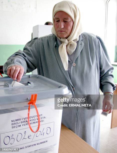 Kosovo ethnic Albanian woman casts her ballot for the general elections in the United Nations-run province of Pristina 23 October 2004. Renewed...