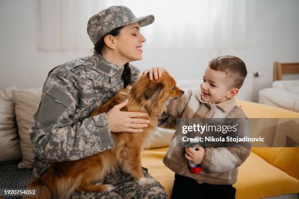 back together again - military uniform at home stock pictures, royalty-free photos & images