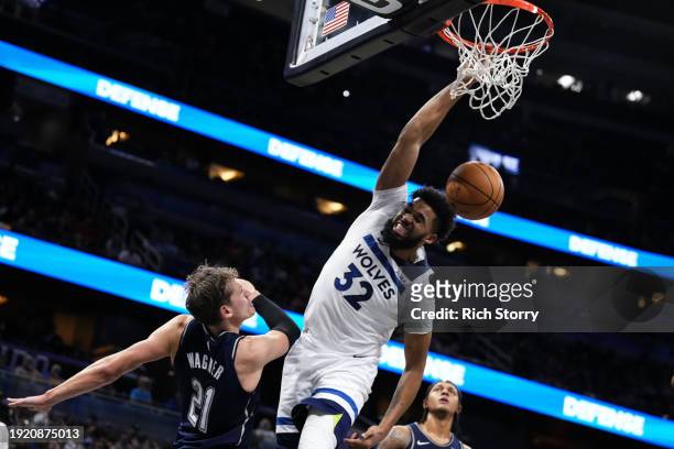 Karl-Anthony Towns of the Minnesota Timberwolves dunks the ball over Moritz Wagner of the Orlando Magic during the second quarter at Kia Center on...