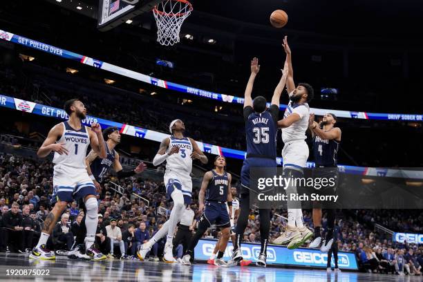 Karl-Anthony Towns of the Minnesota Timberwolves shots over Goga Bitadze of the Orlando Magic during the second quarter at Kia Center on January 09,...