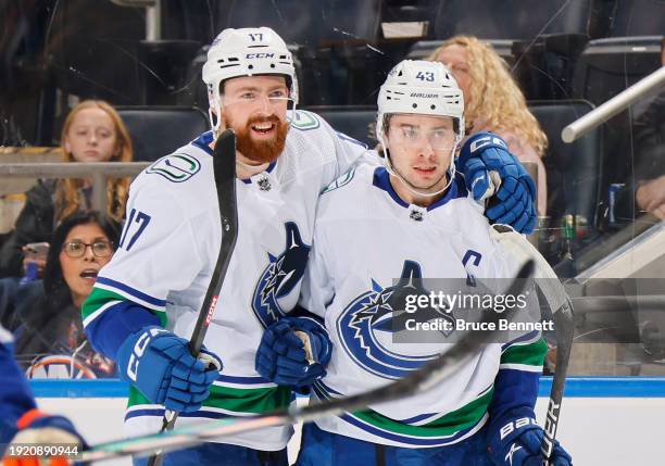 Filip Hronek and Quinn Hughes of the Vancouver Canucks celebrate Hughes first period goal against the New York Islanders at UBS Arena on January 09,...