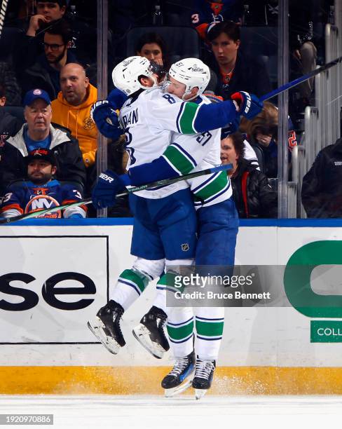 Tyler Myers of the Vancouver Canucks scores at 17:54 of the second period against the New York Islanders and is joined by Conor Garland at UBS Arena...