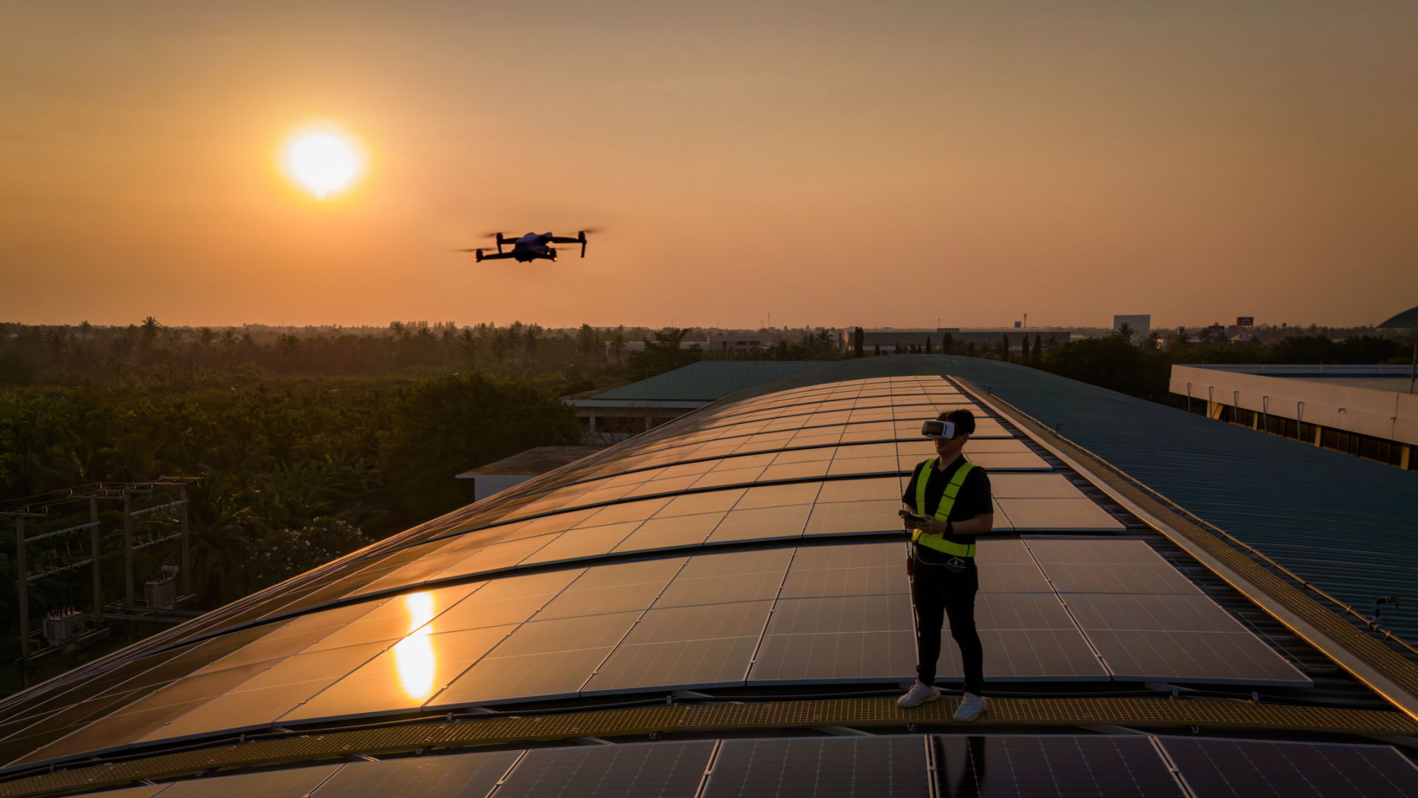 Engineers use drones to explore solar panels or solar cells on the roof top factory. power plant with green fields renewable energy Eco-technology. Inspector engineer inspect and checking solar panel from Drone on solar roof factory Engineers use drones to explore solar panels or solar cells on the roof top factory. power plant with green fields renewable energy Eco-technology. Inspector engineer inspect and checking solar panel from Drone on solar roof factory