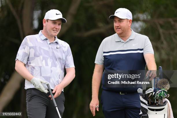 Robert MacIntyre of Scotland talks with caddie Michael Burrows on the fifth hole during a practice round prior to the Sony Open in Hawaii at Waialae...