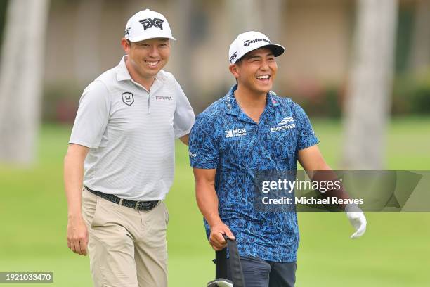 David Lipsky of the United States laughs with Kurt Kitayama of the United States on the fourth hole during a practice round prior to the Sony Open in...