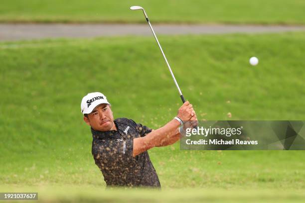 Hideki Matsuyama of Japan plays a shot from a bunker on the fourth hole during a practice round prior to the Sony Open in Hawaii at Waialae Country...