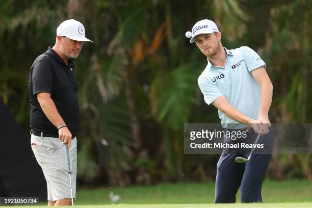 Will Zalatoris of the United States plays a shot on the first hole as coach Josh Gregory looks on during a practice round prior to the Sony Open in...