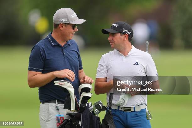 Alejandro Tosti of Argentina talks with his caddie on the third hole during a practice round prior to the Sony Open in Hawaii at Waialae Country Club...