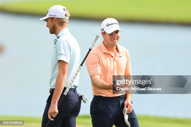 Will Zalatoris of the United States and Pierceson Coody of the United States laugh on the third green during a practice round prior to the Sony Open...