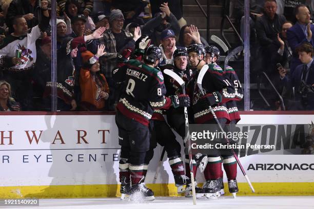 Clayton Keller of the Arizona Coyotes celebrates with Nick Schmaltz, Dylan Guenther and Sean Durzi after Keller scored a a power-play goal against...