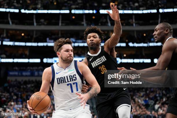 Luka Doncic of the Dallas Mavericks controls the ball as Marcus Smart of the Memphis Grizzlies defends during the first half at American Airlines...