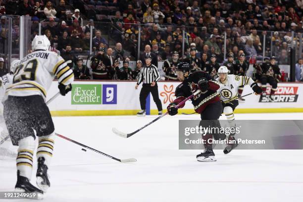 Dylan Guenther of the Arizona Coyotes shoots to score a goal against the Boston Bruins during the second period of the NHL game at Mullett Arena on...