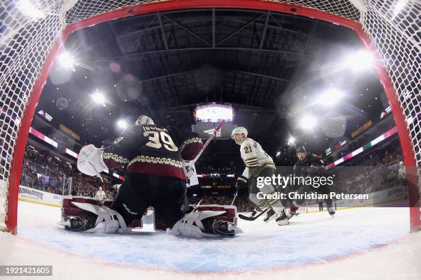 Goaltender Connor Ingram of the Arizona Coyotes allows a a power-play goal to Jake DeBrusk of the Boston Bruins during the third period of the NHL...