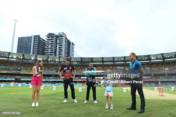 The team captains Aaron Hardie of the Scorchers and Usman Khawaja of the Heat take part in the Bat Flip ahead of the BBL match between the Brisbane...